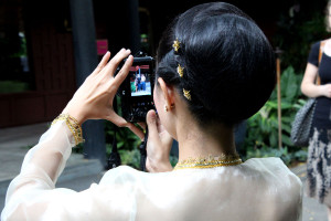 Thai dancer stops to take a picture of tourists