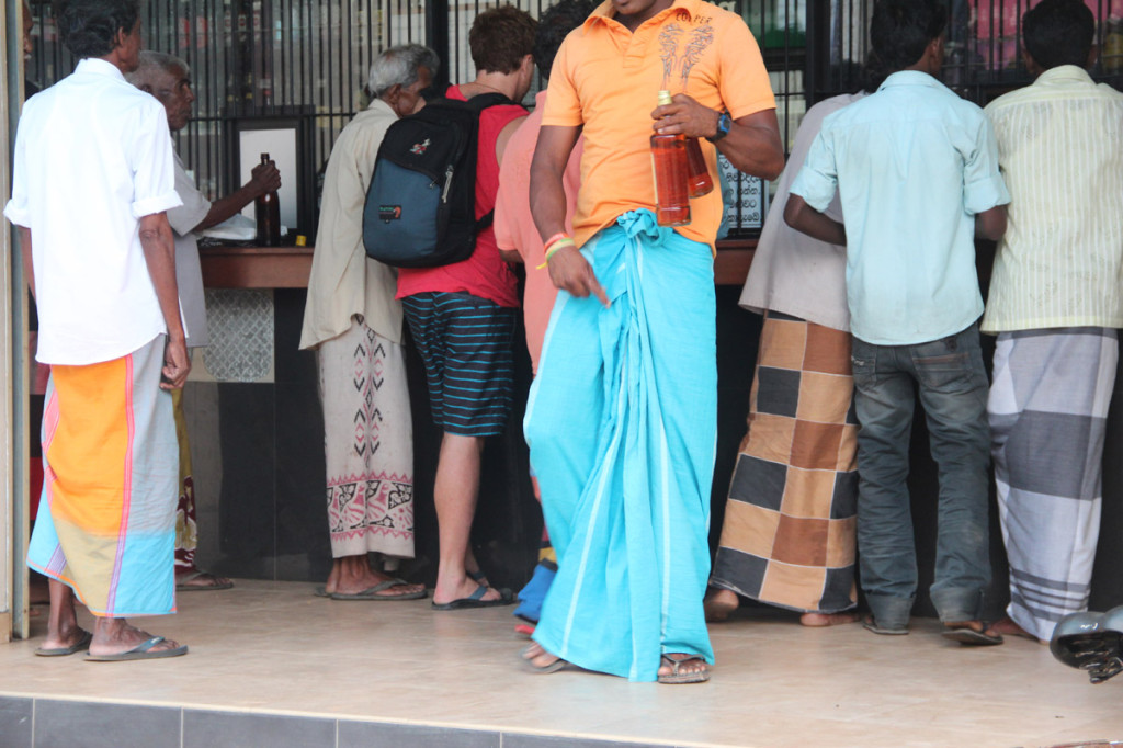 men in sarongs - buying booze